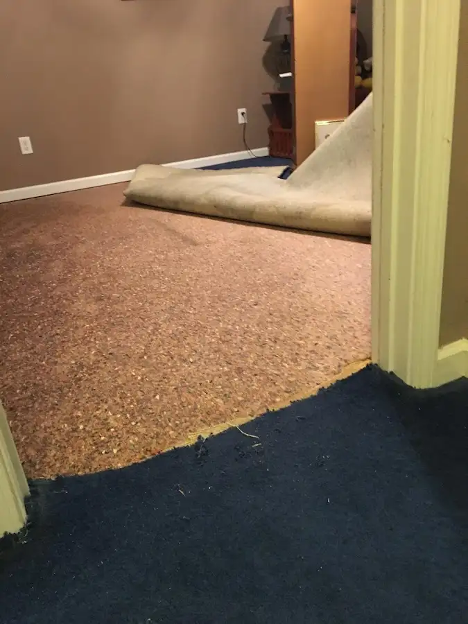 Carpet pad removal revealing water damage during Water Mitigation Services in Lackland AFB